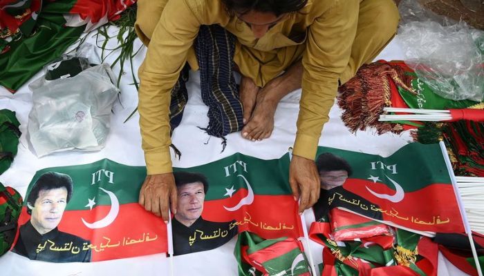 A man selling PTI flags before the rally — AFP