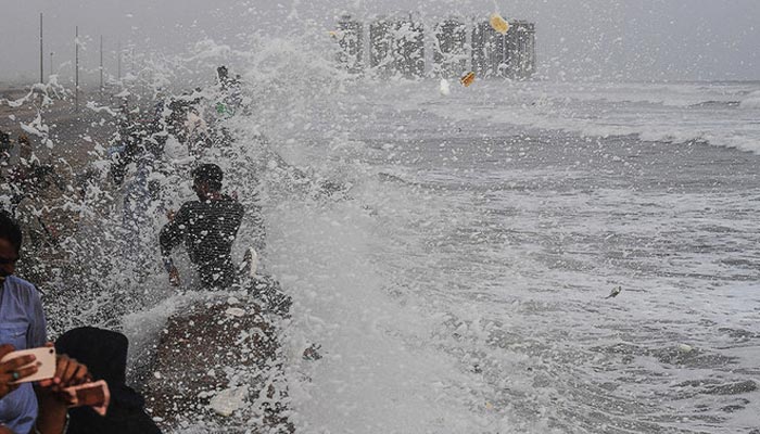 People gather on sea view during high tide of the Arabian Sea in Karachi on June 13, 2019. — AFP/File