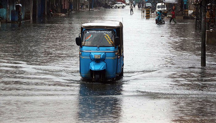 Commuters wade through a flooded road after heavy rainfall at Qadamgah Moula Ali road area in Hyderabad, on August 18, 2022. — Online