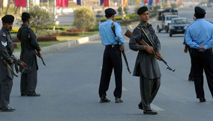 Representational image of Islamabad police and security personnel stand guard at a road. — AFP/File