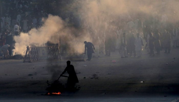 Police use teargas to disperse protestors of Pakistan Tehreek-e-Insaf (PTI) during a demonstration against the decision to disqualify former prime minister Imran Khan running for political office, in Islamabad on October 21, 2022. — AFP