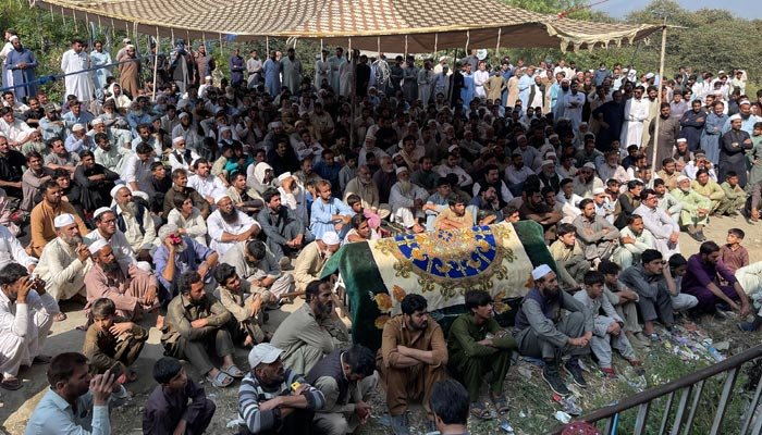 Relatives and residents take part in a protest with the body of a school bus driver a day after he was shot dead in an attack on his bus in Mingora on October 11, 2022. — AFP/File