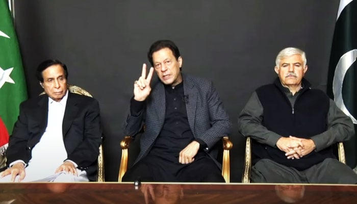 Pakistan Tehreek-e-Insaf Chairman (PTI) Imran Khan addresses supporters while seated alongside CM Punjab Chaudhry Parvez Elahi and KP CM Mahmood Khan. — Screengrab/YouTube/PTI