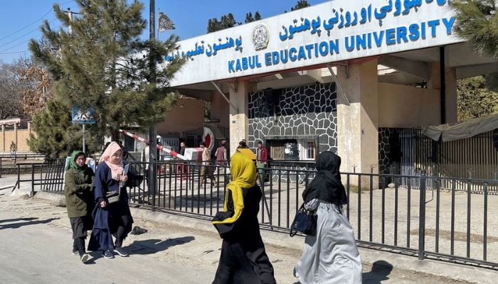 Female students walk in front of the Kabul Education University in Kabul, Afghanistan, February 26, 2022 Reuters