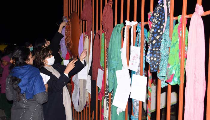 Members of civil society hang their scarves on the Fatima Jinnah Parks main gate while protesting on Saturday against the alleged rape of a girl by two unidentified armed men at the F-9 park in Islamabad on February 6, 2023. — Online