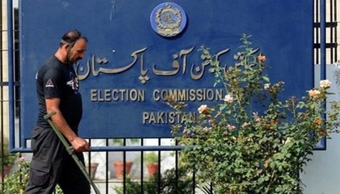 A police official outside the Election Commission of Pakistans office. — AFP/File