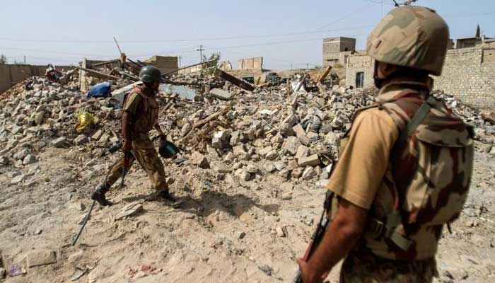Soldiers stand near the debris of a house which was destroyed during a military operation against Taliban militants in the town of Miranshah in North Waziristan July 9, 2014. — Reuters