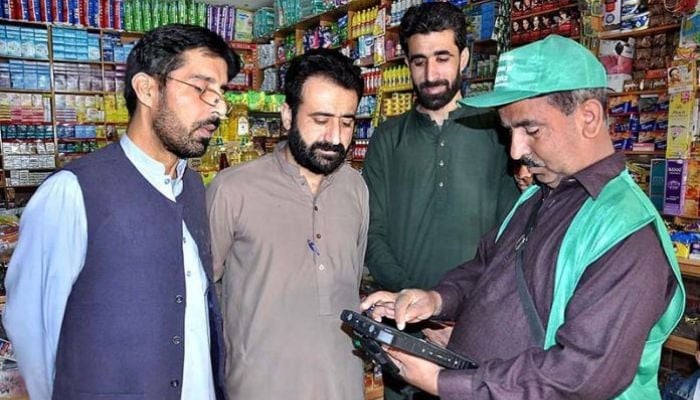 An official from the Pakistan Bureau of Statistics (PBS) collects data from a citizen in Islamabad for the ongoing digital census on March 7, 2023. — APP/File