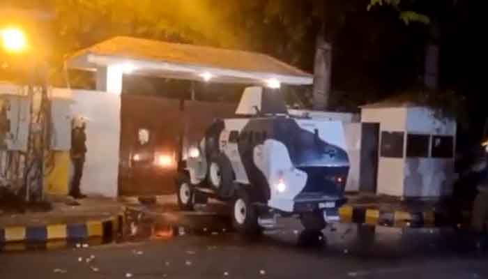 Police used an armoured personnel carrier to break into Parvez Elahis Lahore residence. — PTI video screengrab