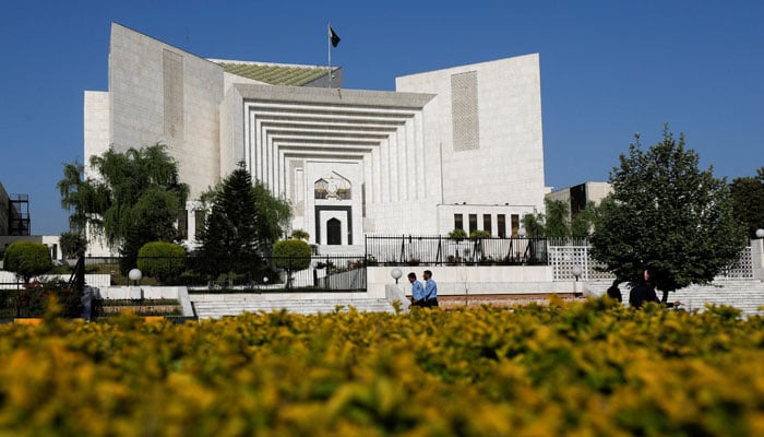 Policemen walk past the Supreme Court building in this undated picture. — Reuters