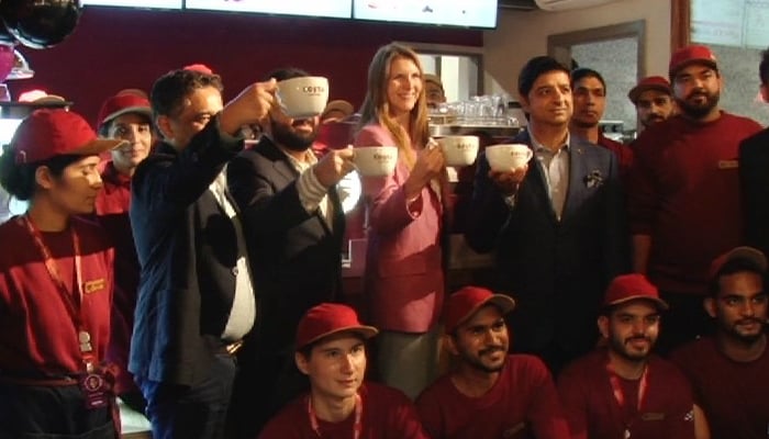 British High Commissioner to Pakistan Jane Marriott (centre) with the staff of a British cafe in Islamabad. — Provided