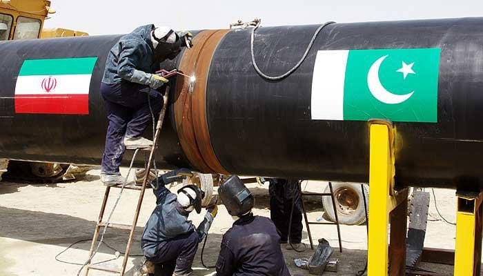 Workers can be seen working on a gas pipeline between Pakistan and Iran. — AFP/File